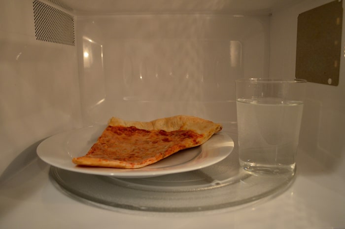 Reheat a pizza in a microwave oven