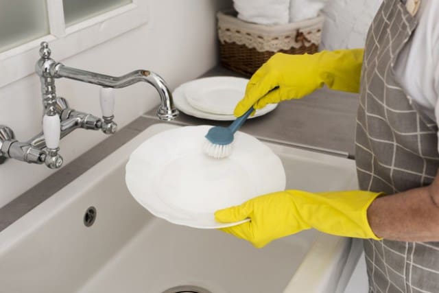 Wash dishes in a farmhouse sink