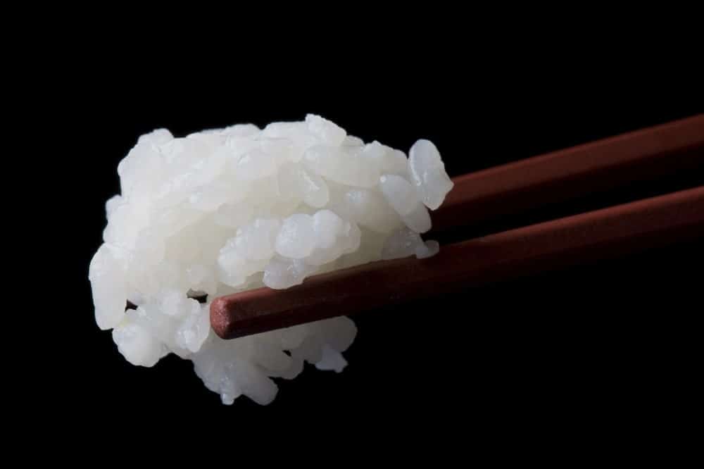 Rice in the chopsticks.