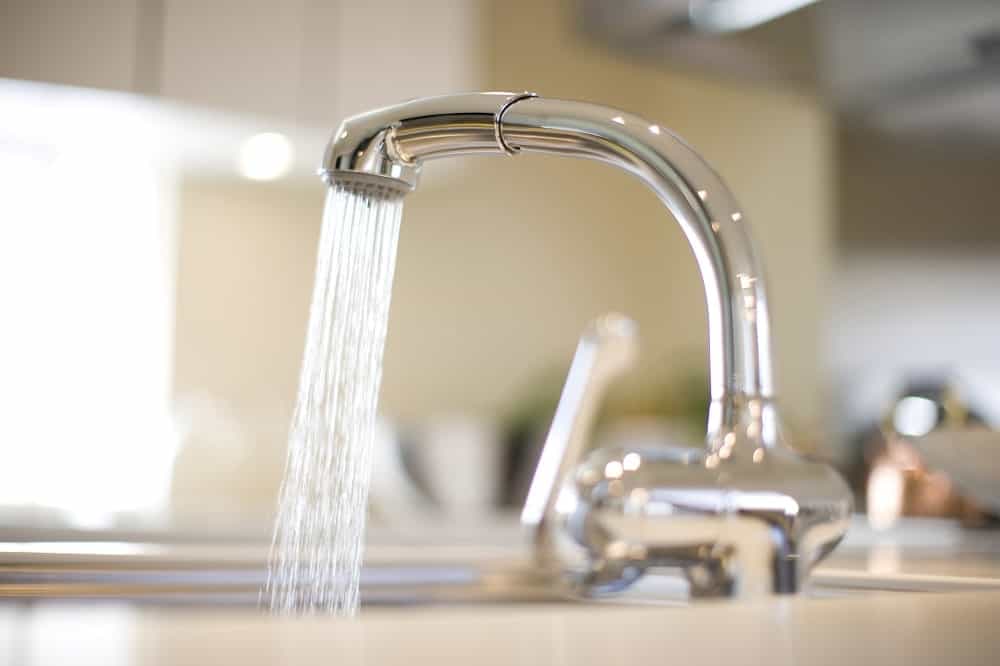 A faucet running water for rinsing rice.