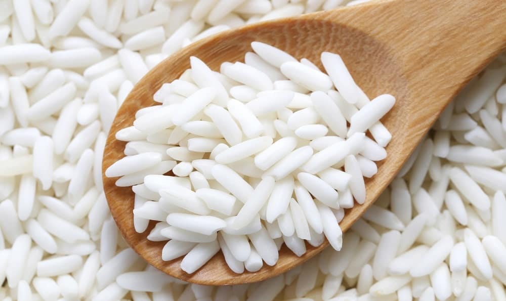 Glutinous white rice in a wooden spoon